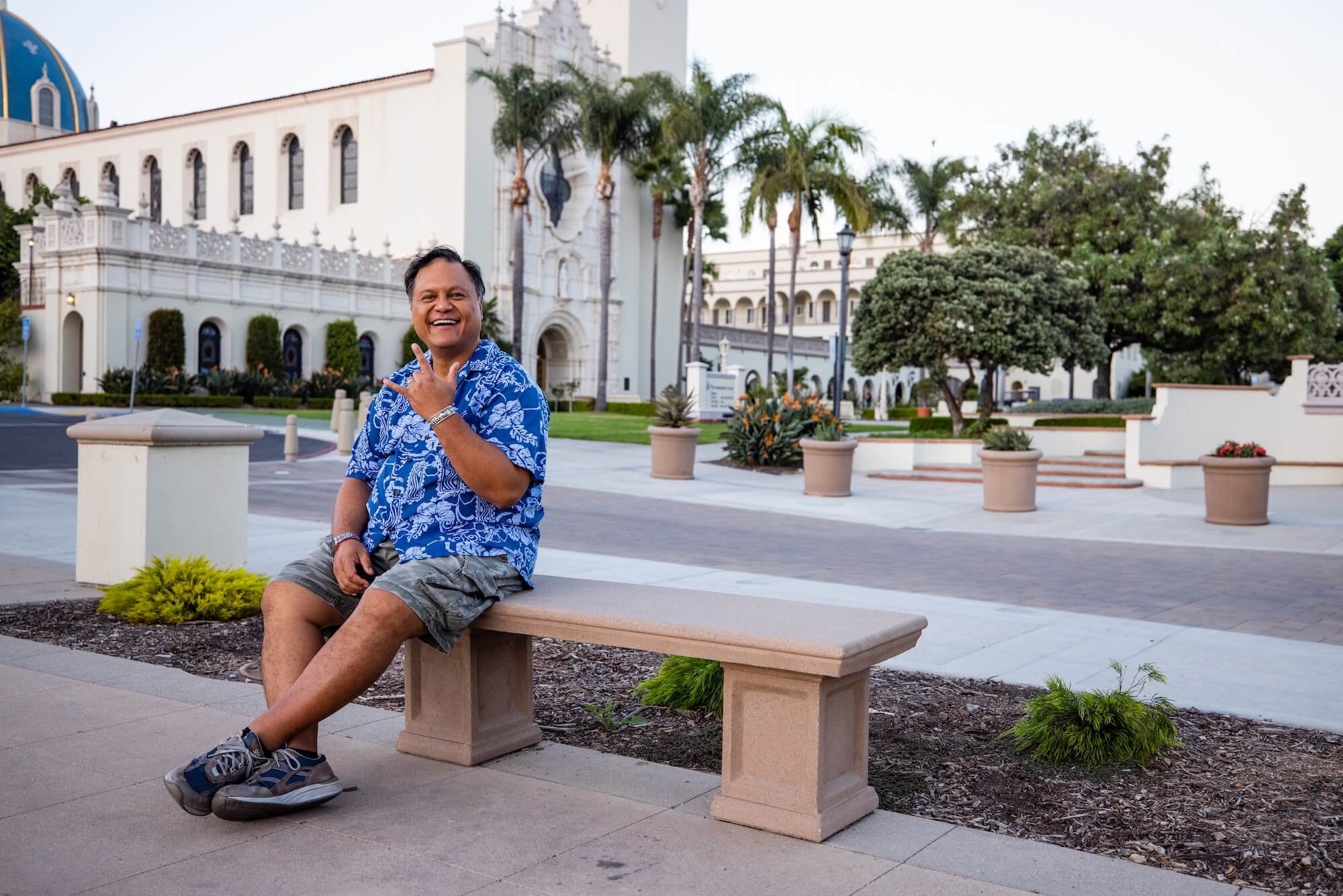 Mr. T sitting on bench at historic university plaza